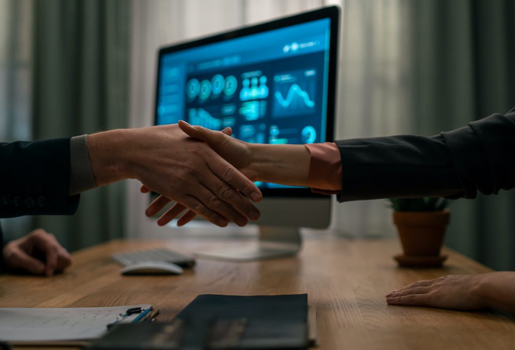 Mature financial advisor shaking hand with his client indoors in office, cut out